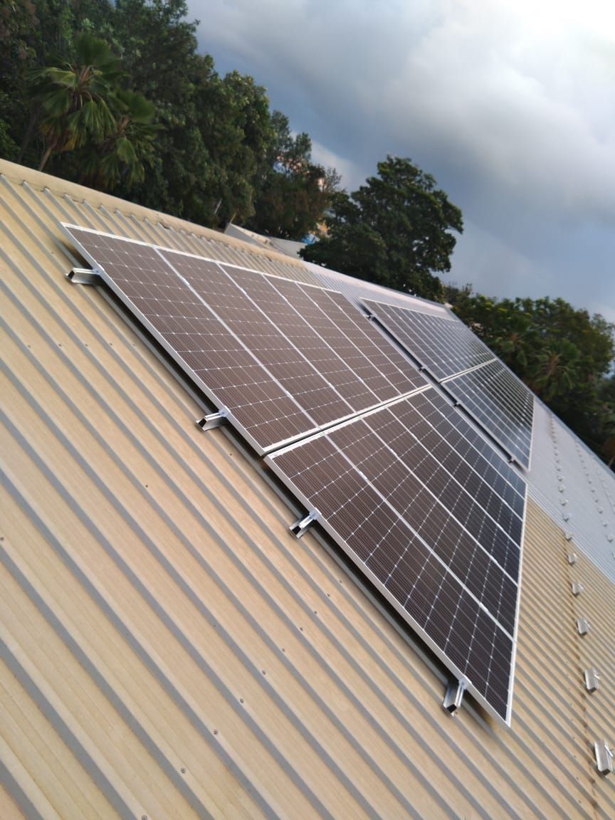 Detail of an installed module row on the metal sheet roof