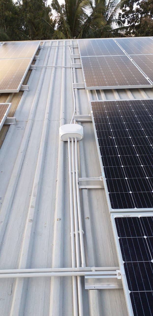 Weatherproof DC conduit routed along the roof ridge into the central junction box